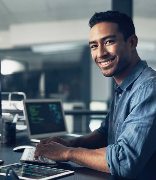 Portrait of a man using a computer in a modern office.
