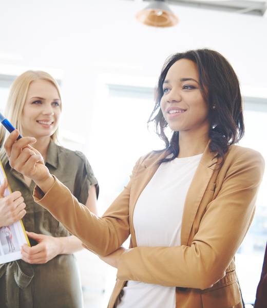 Woman explaining business strategy to coworkers. Cover magazine visable on the picture and property release including